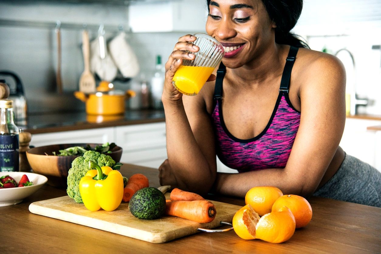 A woman enjoying her juice while looking at the vegetables