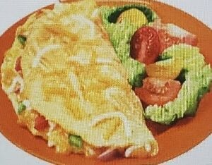 A plate of food with an omelet and salad.