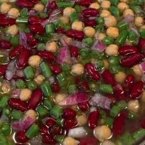 A mixture of beans and vegetables in a bowl.