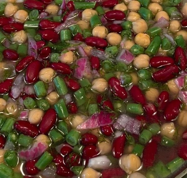 A mixture of beans and vegetables in a bowl.