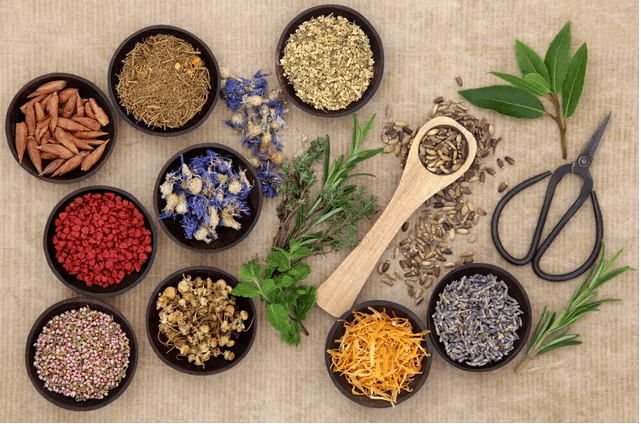 A table topped with bowls of herbs and spices.